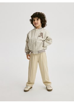Reserved - Dresowe spodnie z przeszyciami - kremowy ze sklepu Reserved w kategorii Spodnie i półśpiochy - zdjęcie 172352966