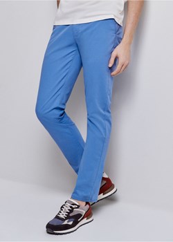 Niebieskie spodnie męskie ze sklepu OCHNIK w kategorii Spodnie męskie - zdjęcie 172557199