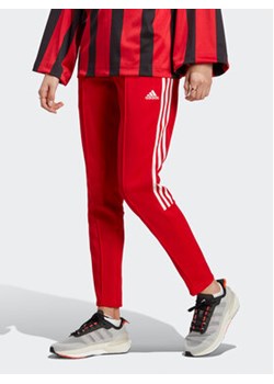 adidas Spodnie dresowe Tiro Suit Up Lifestyle Track Pant IC6679 Czerwony Regular Fit ze sklepu MODIVO w kategorii Spodnie damskie - zdjęcie 172648877