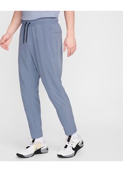 Męskie uniwersalne spodnie ze ściągaczami i zamkami Dri-FIT Nike Unlimited - Niebieski ze sklepu Nike poland w kategorii Spodnie męskie - zdjęcie 173428975
