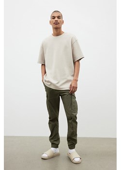 H & M - Joggersy cargo Slim Fit - Zielony ze sklepu H&M w kategorii Spodnie męskie - zdjęcie 173654456