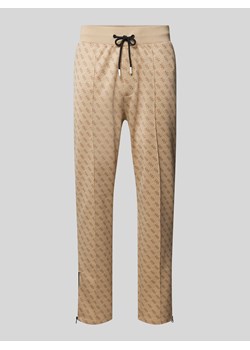 Spodnie dresowe z nadrukiem z logo na całej powierzchni model ‘KORBIN’ ze sklepu Peek&Cloppenburg  w kategorii Spodnie męskie - zdjęcie 173705388
