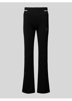 Spodnie materiałowe z poszerzaną nogawką i nadrukiem z logo model ‘TRAIN CORE LADY’ ze sklepu Peek&Cloppenburg  w kategorii Spodnie damskie - zdjęcie 174052889