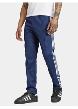 adidas Spodnie dresowe adicolor Classics Beckenbauer IP0421 Niebieski Slim Fit ze sklepu MODIVO w kategorii Spodnie męskie - zdjęcie 177324665