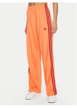 adidas Spodnie dresowe adicolor Classic Firebird JP2309 Pomarańczowy Loose Fit ze sklepu MODIVO w kategorii Spodnie damskie - zdjęcie 177518168