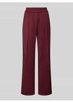Spodnie typu track pants o luźnym kroju z paskami w kontrastowym kolorze model ‘WARM UP X’ ze sklepu Peek&Cloppenburg  w kategorii Spodnie damskie - zdjęcie 177808047