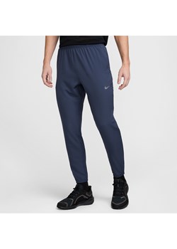 Męskie spodnie do biegania z tkaniny Dri-FIT Nike Challenger - Niebieski ze sklepu Nike poland w kategorii Spodnie męskie - zdjęcie 178602175