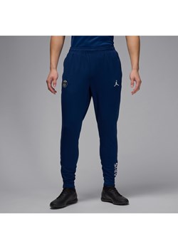 Męskie dzianinowe spodnie piłkarskie Jordan Dri-FIT Paris Saint-Germain Strike (wersja czwarta) - Niebieski ze sklepu Nike poland w kategorii Spodnie męskie - zdjęcie 178604357