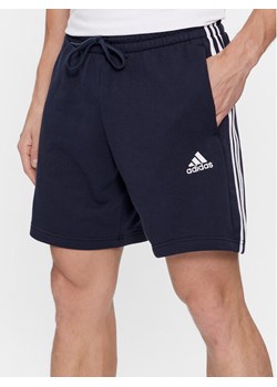 adidas Szorty sportowe Essentials French Terry 3-Stripes Shorts IC9436 Niebieski Regular Fit ze sklepu MODIVO w kategorii Spodenki męskie - zdjęcie 181034416