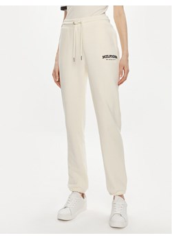 Tommy Hilfiger Spodnie dresowe Monotype WW0WW41572 Beżowy Regular Fit ze sklepu MODIVO w kategorii Spodnie damskie - zdjęcie 181040266