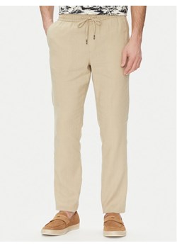 Tommy Hilfiger Spodnie materiałowe Harlem MW0MW38801 Beżowy Slim Fit - id: 0000304650499 - marki Tommy Hilfiger - 181043529 Tommy Hilfiger Spodnie materiałowe Harlem MW0MW38801 Beżowy Slim Fit ze sklepu MODIVO w kategorii Spodnie męskie - zdjęcie 181043529