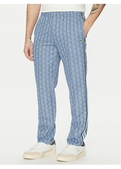 Lacoste Spodnie dresowe XH1440 Niebieski Regular Fit ze sklepu MODIVO w kategorii Spodnie męskie - zdjęcie 181049858