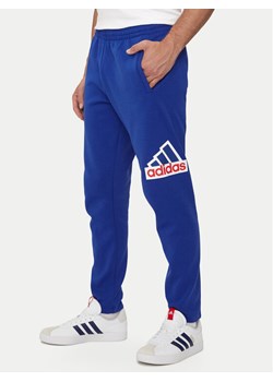 adidas Spodnie dresowe Future Icons Badge of Sport IS9594 Niebieski Regular Fit ze sklepu MODIVO w kategorii Spodnie męskie - zdjęcie 181060625