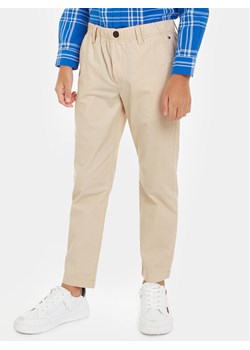 Tommy Hilfiger Spodnie materiałowe KB0KB08895 Beżowy Regular Fit ze sklepu MODIVO w kategorii Spodnie chłopięce - zdjęcie 181063226