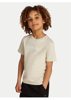 Calvin Klein Jeans T-Shirt IU0IU00682 Beżowy Regular Fit ze sklepu MODIVO w kategorii Bluzki dziewczęce - zdjęcie 181095935