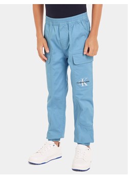 Calvin Klein Jeans Joggery IB0IB01675 Niebieski Regular Fit ze sklepu MODIVO w kategorii Spodnie chłopięce - zdjęcie 181102656