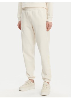 DKNY Spodnie dresowe DP5P3585 Beżowy Regular Fit ze sklepu MODIVO w kategorii Spodnie damskie - zdjęcie 181111515