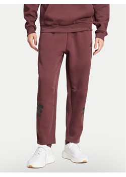 adidas Spodnie dresowe Future Icons 3-Stripes JD4888 Bordowy Loose Fit ze sklepu MODIVO w kategorii Spodnie męskie - zdjęcie 181122186