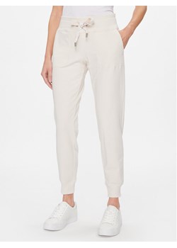 DKNY Sport Spodnie dresowe DP2P1917 Beżowy Classic Fit ze sklepu MODIVO w kategorii Spodnie damskie - zdjęcie 181140935