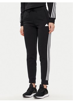 adidas Spodnie dresowe Future Icons 3-Stripes IN9479 Czarny Regular Fit ze sklepu MODIVO w kategorii Spodnie damskie - zdjęcie 181150017