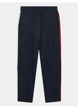 Tommy Hilfiger Spodnie dresowe KG0KG07407 Granatowy Regular Fit ze sklepu MODIVO w kategorii Spodnie chłopięce - zdjęcie 181156766
