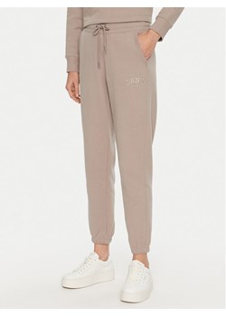 DKNY Sport Spodnie dresowe DP4P3471 Beżowy Regular Fit ze sklepu MODIVO w kategorii Spodnie damskie - zdjęcie 181172669