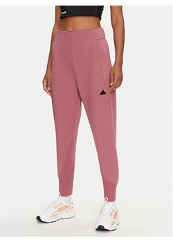 adidas Spodnie dresowe Z.N.E. IW7771 Różowy Regular Fit ze sklepu MODIVO w kategorii Spodnie damskie - zdjęcie 181176807