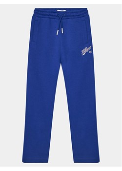 Tommy Hilfiger Spodnie dresowe Hilfiger Script Wide Sweatpant KG0KG07751 Niebieski Regular Fit ze sklepu MODIVO w kategorii Spodnie chłopięce - zdjęcie 181177396