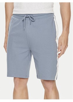 Tommy Hilfiger Szorty sportowe UM0UM03008 Niebieski Regular Fit ze sklepu MODIVO w kategorii Spodenki męskie - zdjęcie 181177765