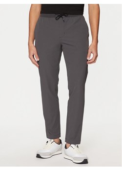 Calvin Klein Joggery K10K113809 Szary Slim Fit ze sklepu MODIVO w kategorii Spodnie męskie - zdjęcie 181179638