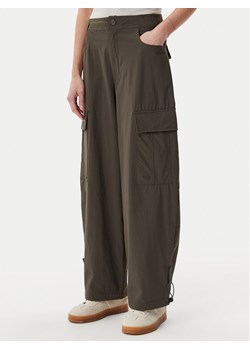 adidas Spodnie materiałowe Premium Essentials JD4785 Khaki Loose Fit ze sklepu MODIVO w kategorii Spodnie damskie - zdjęcie 181183765