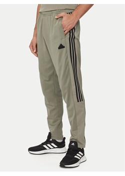 adidas Spodnie dresowe Tiro IS1504 Zielony Regular Fit ze sklepu MODIVO w kategorii Spodnie męskie - zdjęcie 181185657