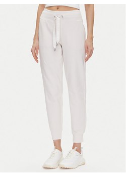 DKNY Sport Spodnie dresowe DP5P3496 Beżowy Regular Fit ze sklepu MODIVO w kategorii Spodnie damskie - zdjęcie 181194339