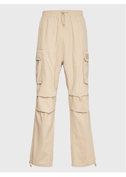 Karl Kani Spodnie materiałowe Rubber Signature 6002506 Beżowy Relaxed Fit ze sklepu MODIVO w kategorii Spodnie męskie - zdjęcie 181200426