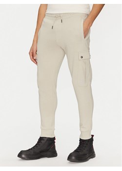 BOSS Spodnie dresowe Seteam 50542917 Beżowy Regular Fit ze sklepu MODIVO w kategorii Spodnie męskie - zdjęcie 182602216