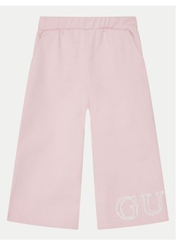 Guess Spodnie dresowe K5RQ11 KA6R4 Różowy Regular Fit ze sklepu MODIVO w kategorii Spodnie dziewczęce - zdjęcie 182602918
