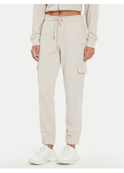 DKNY Sport Spodnie dresowe DP4P3505 Szary Regular Fit ze sklepu MODIVO w kategorii Spodnie damskie - zdjęcie 182603896