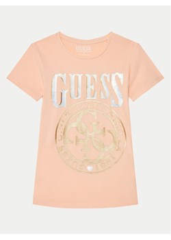 Guess T-Shirt J5RI20 K6YW4 Koralowy Regular Fit ze sklepu MODIVO w kategorii Bluzki dziewczęce - zdjęcie 182605039