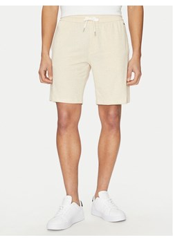 Tommy Hilfiger Szorty sportowe UM0UM03364 Beżowy Regular Fit ze sklepu MODIVO w kategorii Spodenki męskie - zdjęcie 182607887