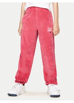 Tommy Hilfiger Spodnie dresowe Script Velour KG0KG08221 Różowy Regular Fit ze sklepu MODIVO w kategorii Spodnie dziewczęce - zdjęcie 182613299
