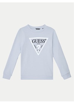 Guess Bluza J74Q10 KAUG0 Błękitny Regular Fit ze sklepu MODIVO w kategorii Bluzy chłopięce - zdjęcie 182621745