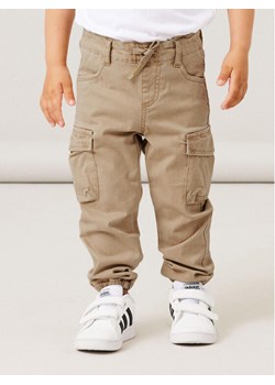 NAME IT Joggery 13212620 Beżowy Baggy Fit ze sklepu MODIVO w kategorii Spodnie chłopięce - zdjęcie 182627315