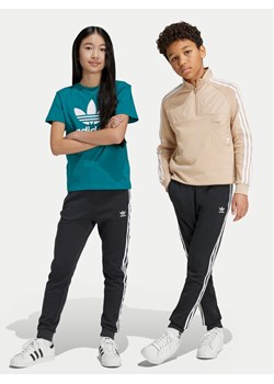 adidas Spodnie dresowe Trefoil IY7484 Czarny Regular Fit ze sklepu MODIVO w kategorii Spodnie chłopięce - zdjęcie 182640589