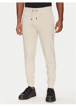 Guess Spodnie dresowe 2YB22 KAIJ1 Écru Regular Fit ze sklepu MODIVO w kategorii Spodnie męskie - zdjęcie 182654787