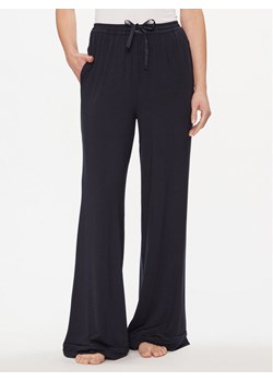 Tommy Hilfiger Spodnie dresowe UW0UW05195 Granatowy Relaxed Fit ze sklepu MODIVO w kategorii Spodnie damskie - zdjęcie 182658788