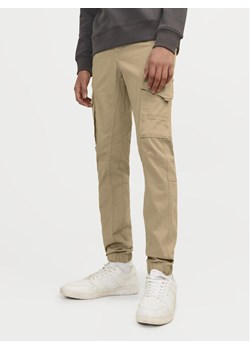 Jack&Jones Junior Spodnie materiałowe Paul 12193900 Beżowy Slim Fit ze sklepu MODIVO w kategorii Spodnie chłopięce - zdjęcie 182669347
