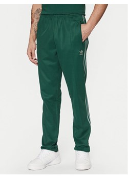 adidas Spodnie dresowe adicolor Classics Beckenbauer JP2523 Zielony Slim Fit ze sklepu MODIVO w kategorii Spodnie męskie - zdjęcie 182670716