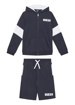 Guess Komplet dziecięcy L5GG00 KA6R4 Granatowy Regular Fit ze sklepu MODIVO w kategorii Dresy chłopięce - zdjęcie 182674048