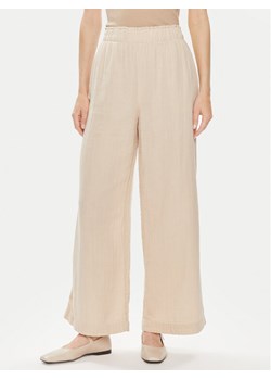 Gap Spodnie materiałowe 855967-01 Beżowy Relaxed Fit ze sklepu MODIVO w kategorii Spodnie damskie - zdjęcie 182674296