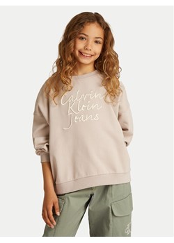 Calvin Klein Jeans Bluza IG0IG02760 Beżowy Regular Fit ze sklepu MODIVO w kategorii Bluzy dziewczęce - zdjęcie 182698756